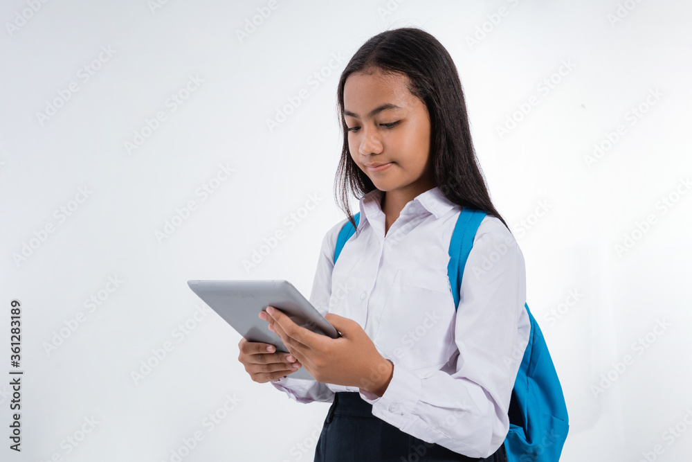 girl junior high school student using tablet pc over white background girl junior high school student using tablet pc over white background