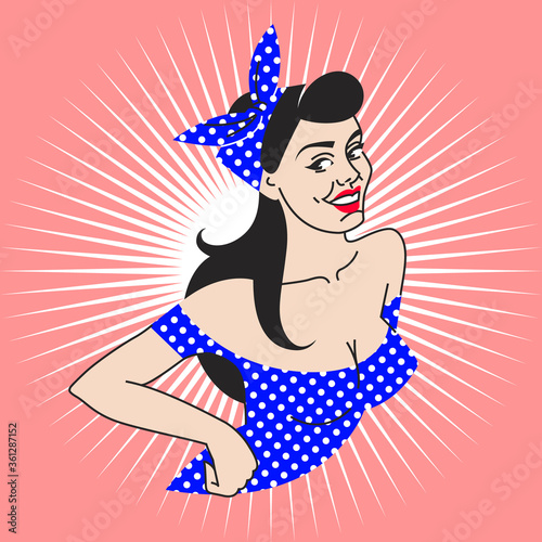pin-up girl in a blue dress and a white polka dots scarf on pink background. portrait young brunette with deep neckline, red lips in retro style.