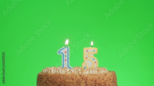 Lighting a number four birthday candle on a delicious cake, green screen 15