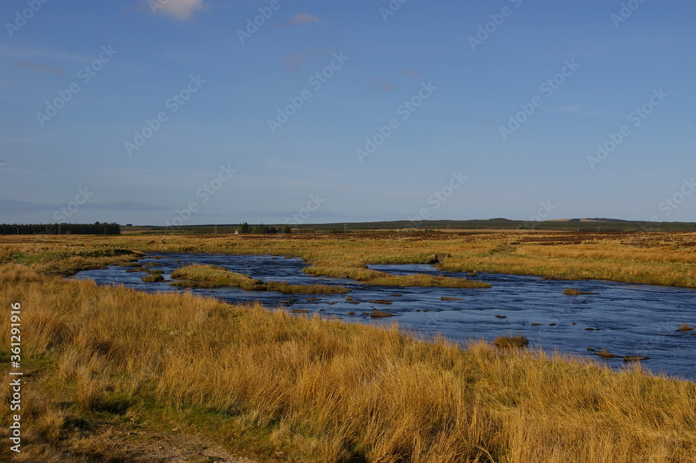 The Thurso River flowing through the flat countryside near Westerdale, Caithness, in the Scottish Highlands.