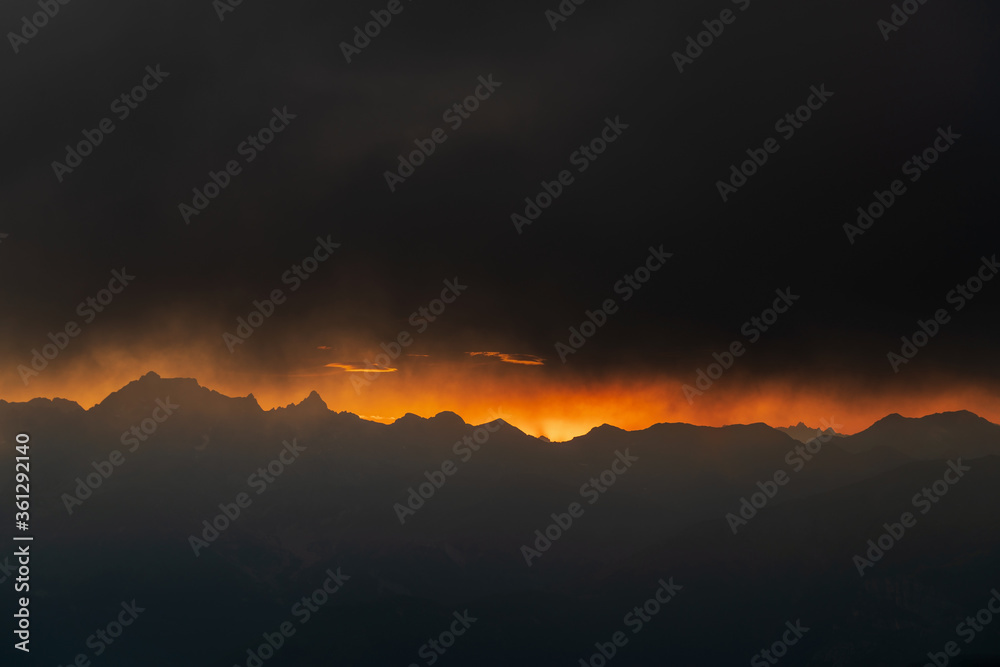 Cloudy sky against the sun over Maritime Alps mountain range, South France Cloudy sky against the sun over Maritime Alps mountain range, South France