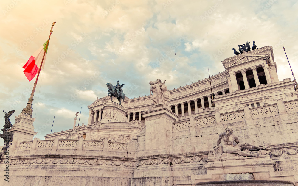 Rome Italy, King Vittorio Emanuele monument impressive facade under cloudy sky, filtered image