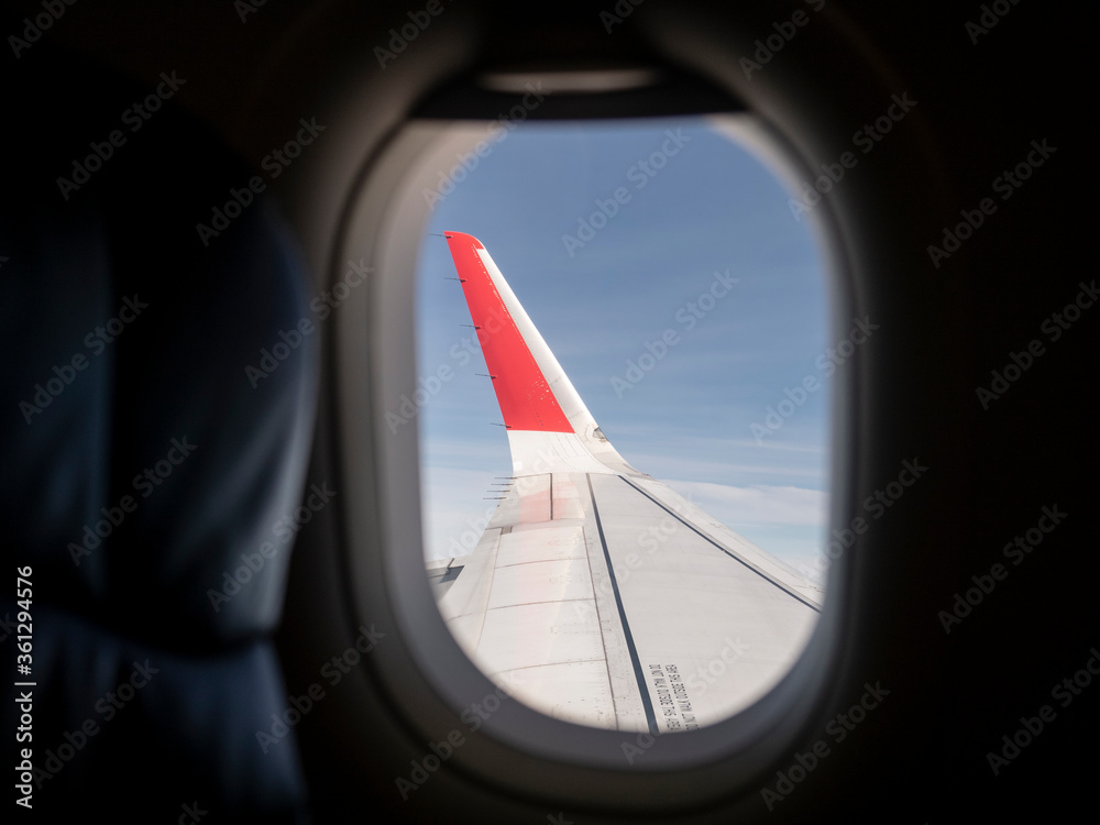 Aircraft winglet or wingtip from window seat. Blue sky Background