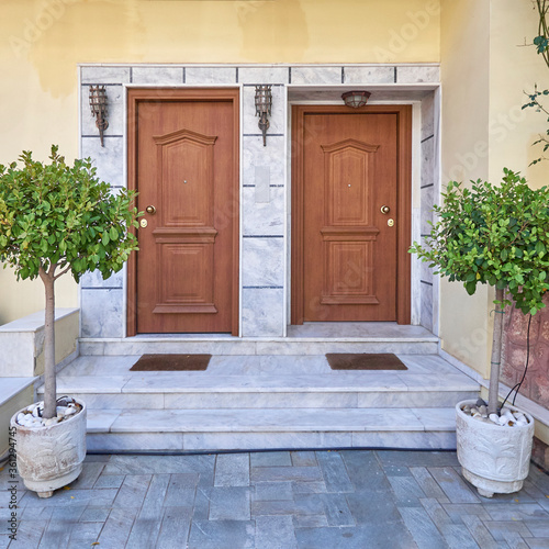 Contemporary two family house entrance doors with potted plants, Athens Greece