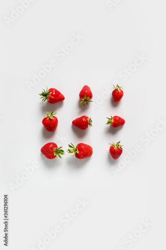 Top view background with organic and tasty strawberry berries frame on a white background