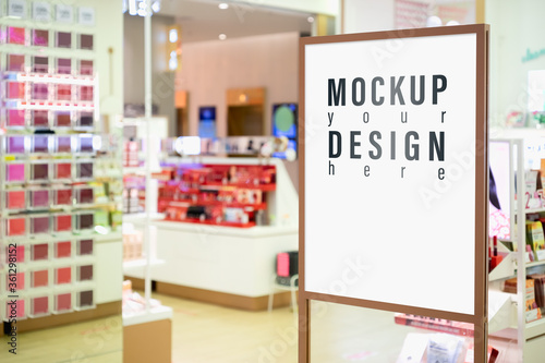 Mock up of vertical poster billboard with blurred cosmetic shop background.