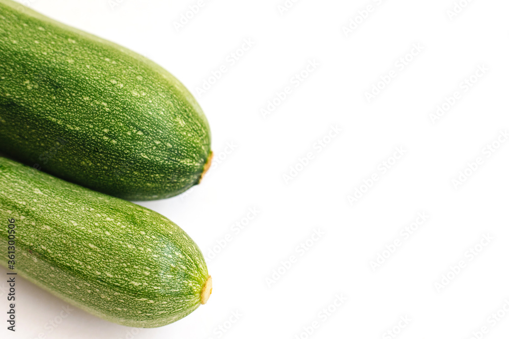 Green zucchini on a white background. The harvest of zucchini.Green vegetables. Green zucchini on a white background. The harvest of zucchini.Green vegetables.