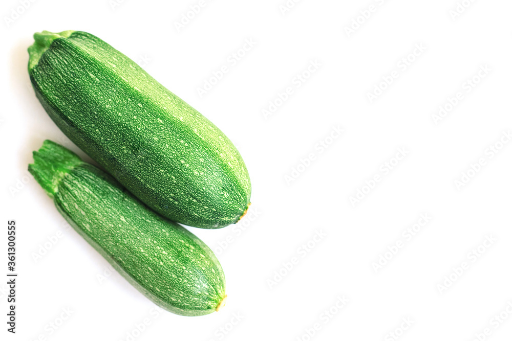 Green zucchini on a white background. The harvest of zucchini.Green vegetables. Green zucchini on a white background. The harvest of zucchini.Green vegetables.