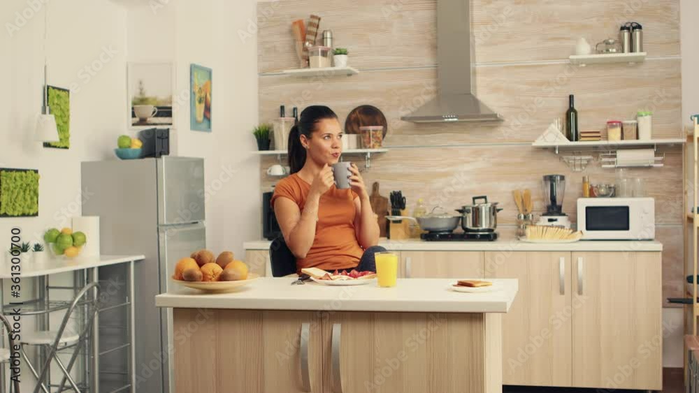 Young woman relaxing and drinking coffee in the morning. Lady ejoying a cup of coffee in the morning. Lady ejoying a cup of coffee in the morning. Happy housewife relaxing and spoiling herself with a Young woman relaxing and drinking coffee in the morning. Lady ejoying a cup of coffee in the morning. Lady ejoying a cup of coffee in the morning. Happy housewife relaxing and spoiling herself with a
