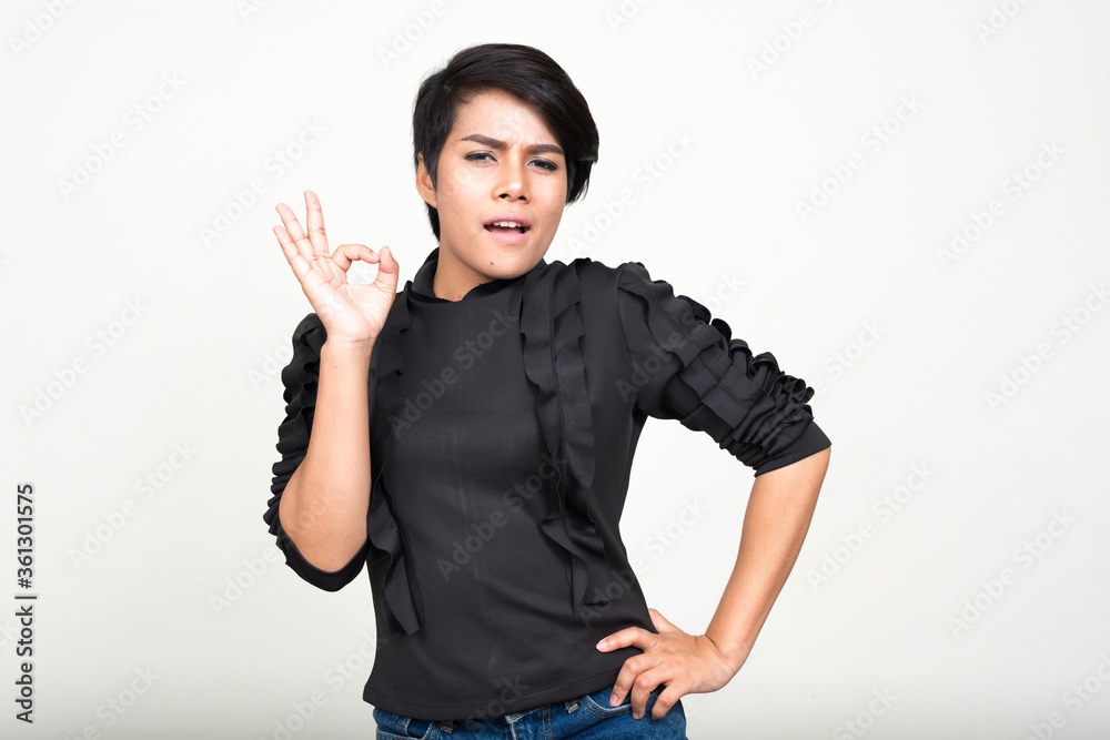 Portrait of young Asian businesswoman giving ok sign Portrait of young Asian businesswoman giving ok sign
