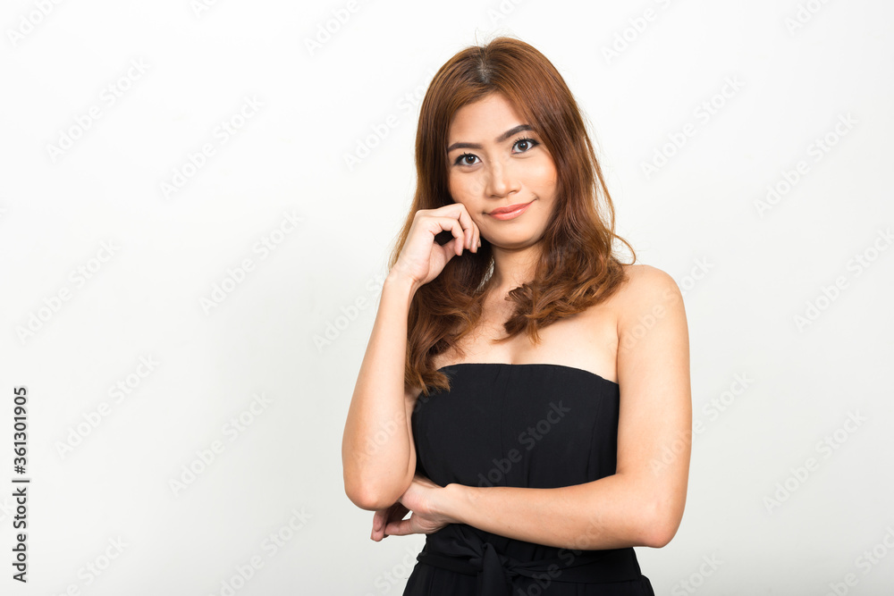 Portrait of young beautiful Asian woman thinking