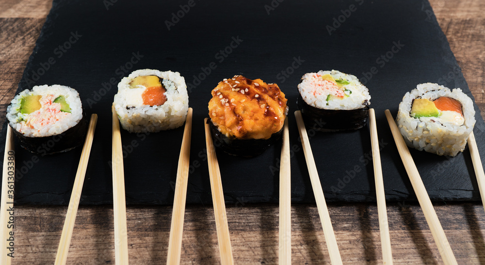 Sushi roll set on the black plate. Japanese food. Sushi roll set on the black plate. Japanese food.