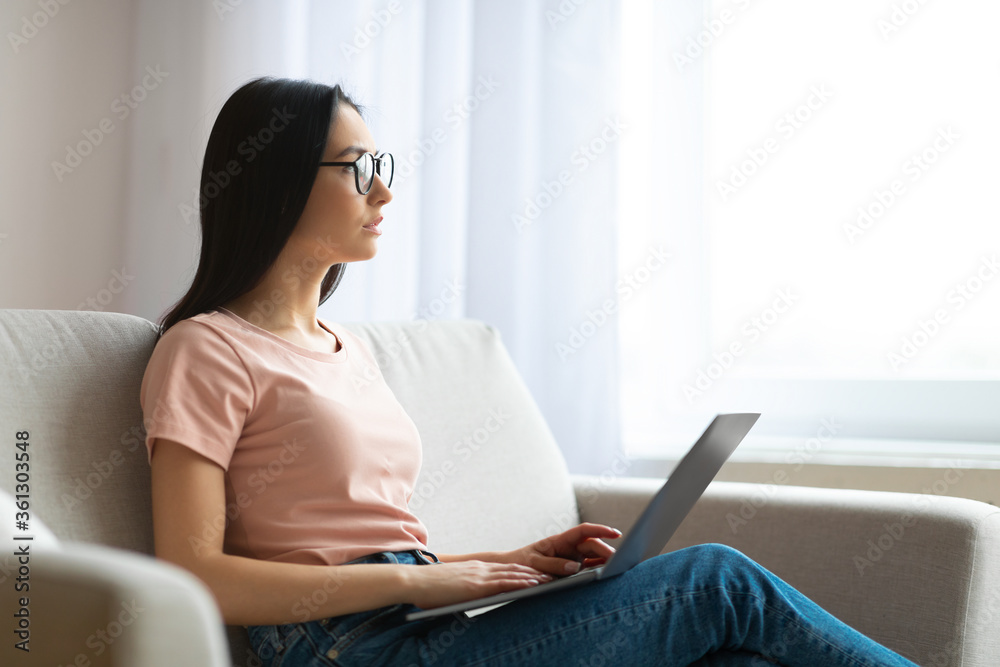 Student Girl Using Laptop Thinking Sitting On Sofa At Home Student Girl Using Laptop Thinking Sitting On Sofa At Home