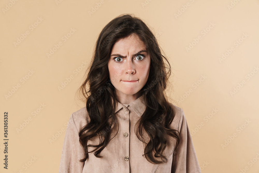 Image of angry cute woman posing and looking at camera