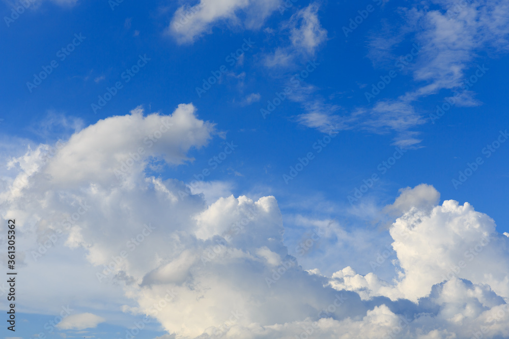 Fototapeta premium White clouds against the blue sky background in sunny cloudy summer day.