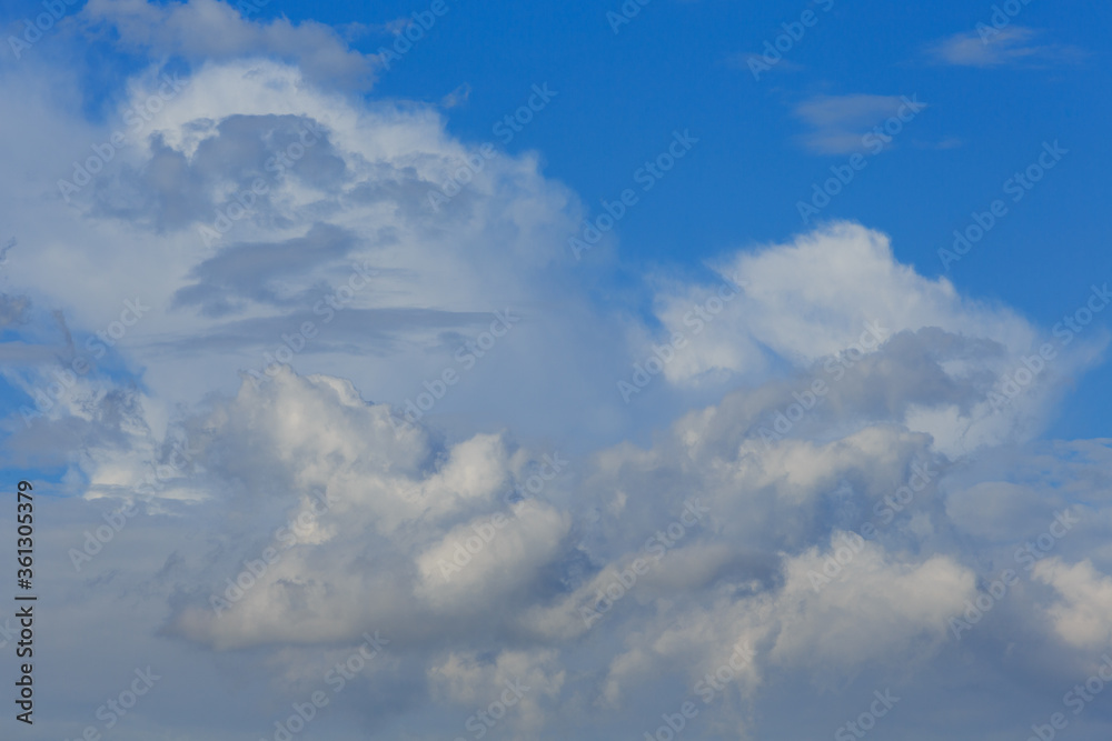Fototapeta premium White clouds against the blue sky background in sunny cloudy summer day.