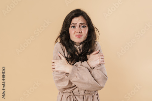 Image of unhappy brunette nice woman trembling and filling cold