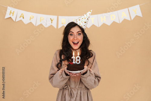 Canvas Print Image of excited young woman smiling while posing with birthday cake
