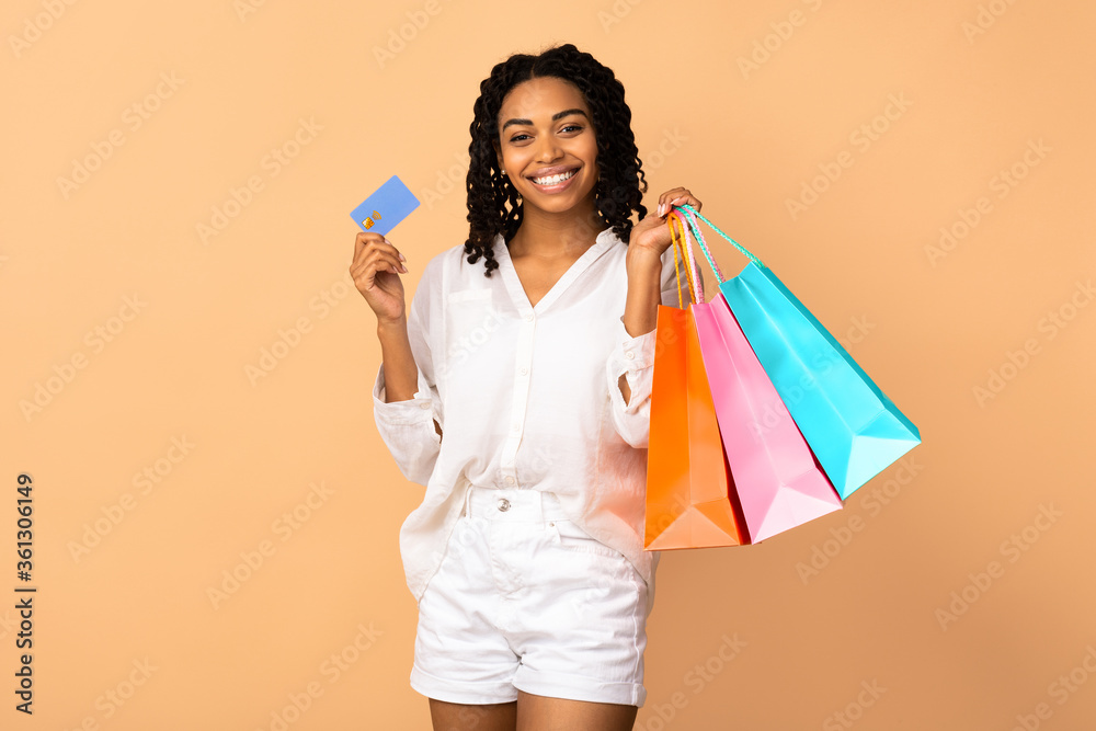 African Woman Holding Credit Card And Shopping Bags, Studio Shot African Woman Holding Credit Card And Shopping Bags, Studio Shot