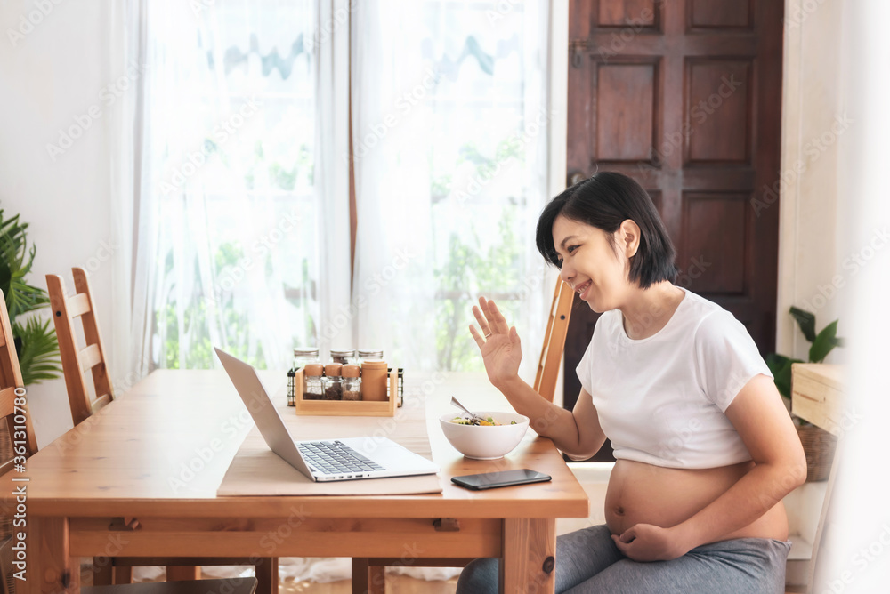 Young Asian Mother makes video call for talking with family on laptop Young Asian Mother makes video call for talking with family on laptop