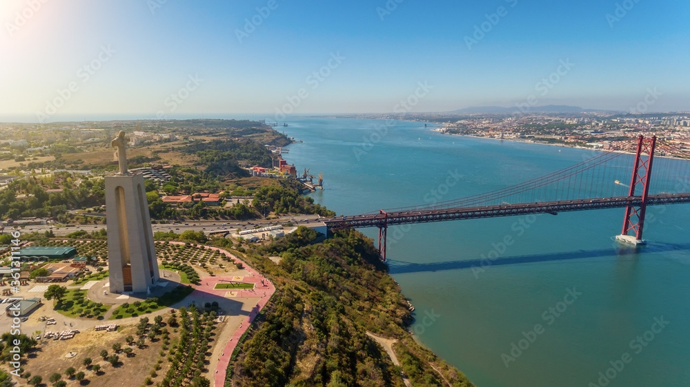 Aerial bridge on April 25th, across the Tejo River, statue of Jesus Christ Lisbon, Portugal. Close-up.