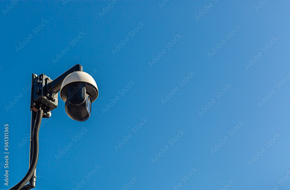 City monitoring. Public safety. CCTV camera against the blue sky. City monitoring. Public safety. CCTV camera against the blue sky.