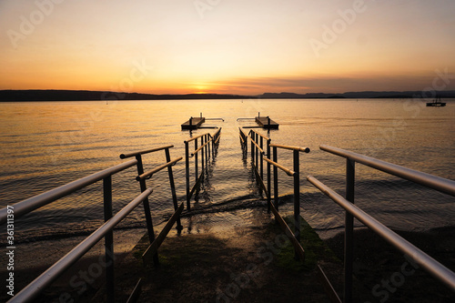 Bridge of a lake with mountains in a sunset