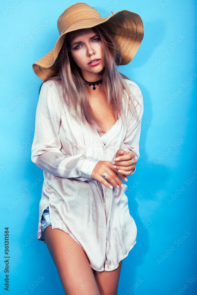 Naklejka premium young pretty girl in big hat posing happy smiling on blue background, lifestyle people on summer vacation concept