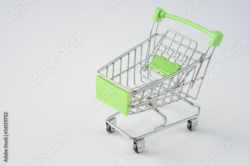 Small shopping cart on gray background. shopping concept