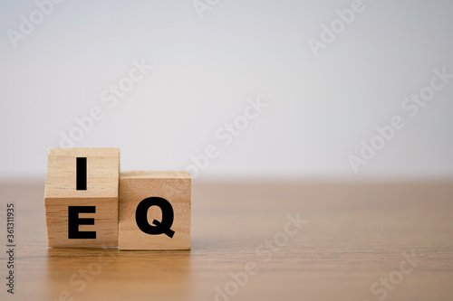 Flipping of EQ to IQ which print screen on wooden cube block. Smart idea and smart emotion concept.