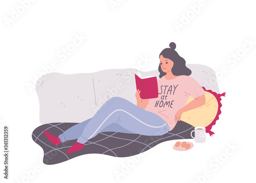 Coronavirus 2019-nCoV. Young woman staying at home , lying on the couch and reading a book during coronavirus quarantine. China pathogen respiratory infection .Influenza pandemic. Flu outbreak.