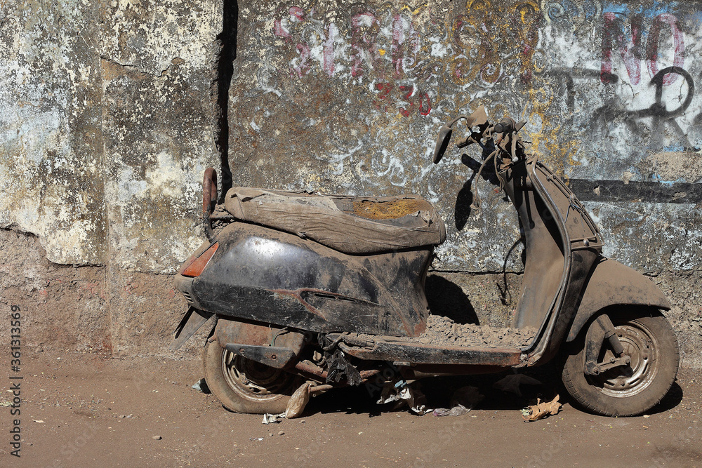 old motorcycle against the background of the textured wall
