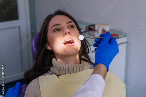 attractive woman visiting dentist  doctor doing dental examinati