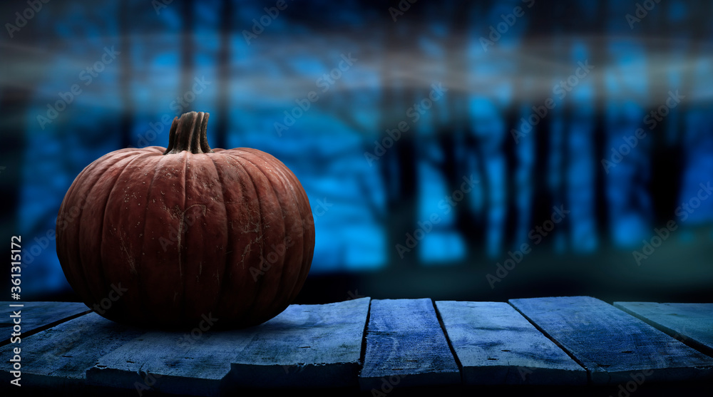 One spooky halloween pumpkin blank template on a wooden bench with a misty forest night background with space for product placement. - obrazy, fototapety, plakaty 