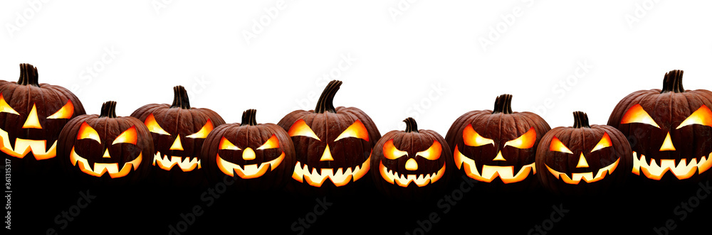A large group of nine spooky halloween lanterns, Jack O Lantern, with evil face and eyes isolated against a white background.