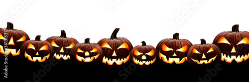 Obraz na płótnie A large group of nine spooky halloween lanterns, Jack O Lantern, with evil face and eyes isolated against a white background. w salonie