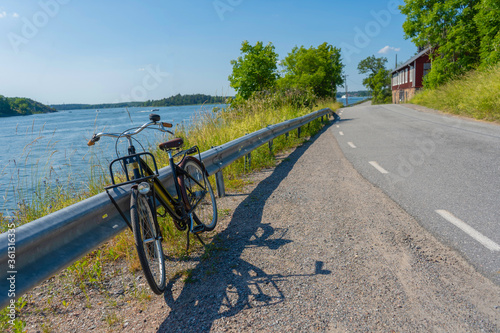The old bicycle on the side of the road. Rindo island near Vaxholm in Stockholm archipelago. Countryside photo. Sweden. Scandinavia