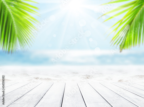 Wooden table top on blue sea and white sand beach background.