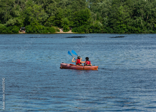 Two people kayaking on the river