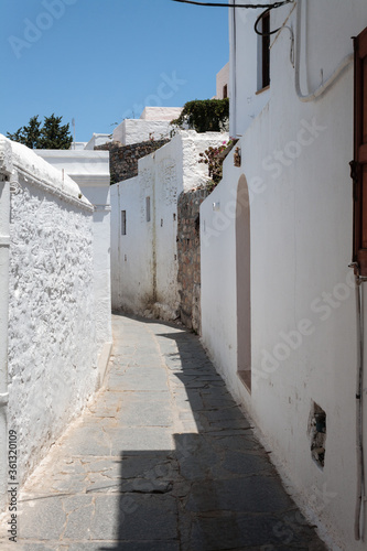 Greek small street with white painted walls
