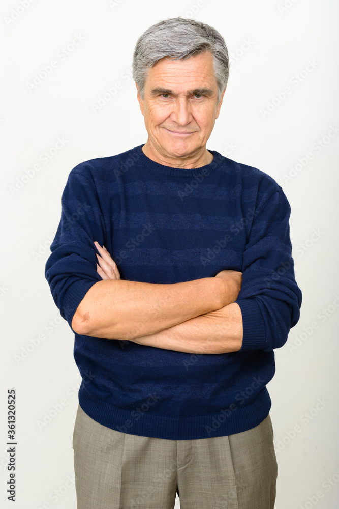Portrait of happy handsome senior man smiling with arms crossed Portrait of happy handsome senior man smiling with arms crossed