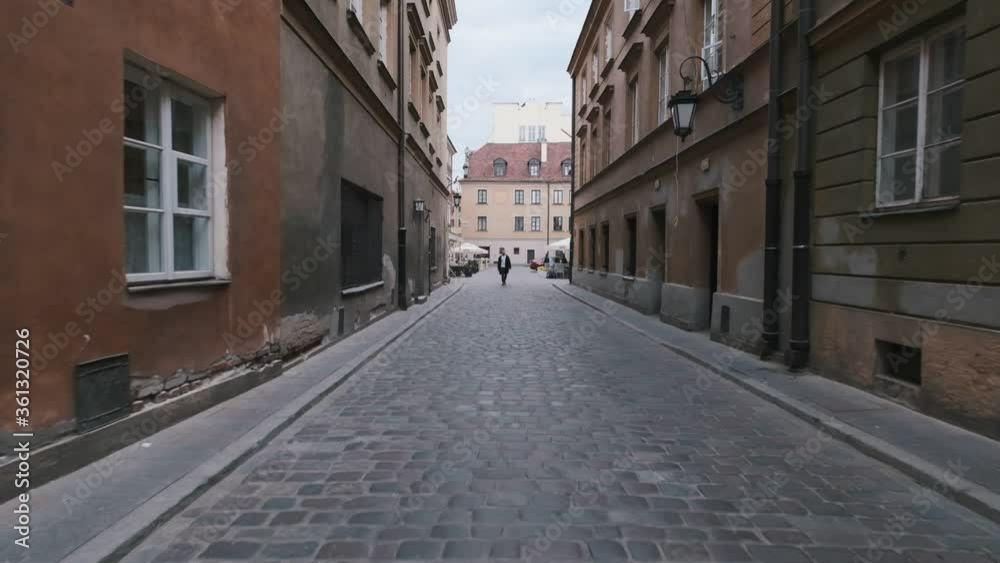 Handsome bearded man walking in the street in old town. Warsaw, Poland Handsome bearded man walking in the street in old town. Warsaw, Poland