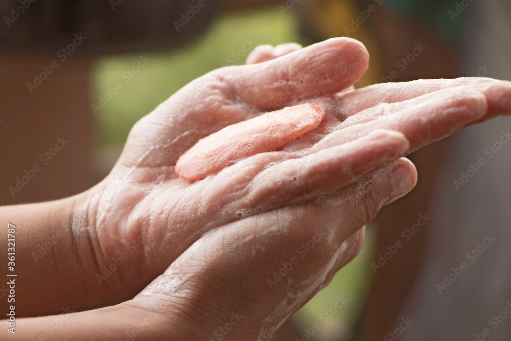 child washing hands with soap during covid pandemic