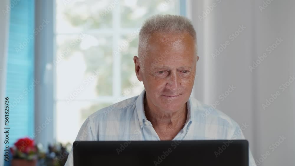 Senior man working with laptop computer at home office Senior man working with laptop computer at home office