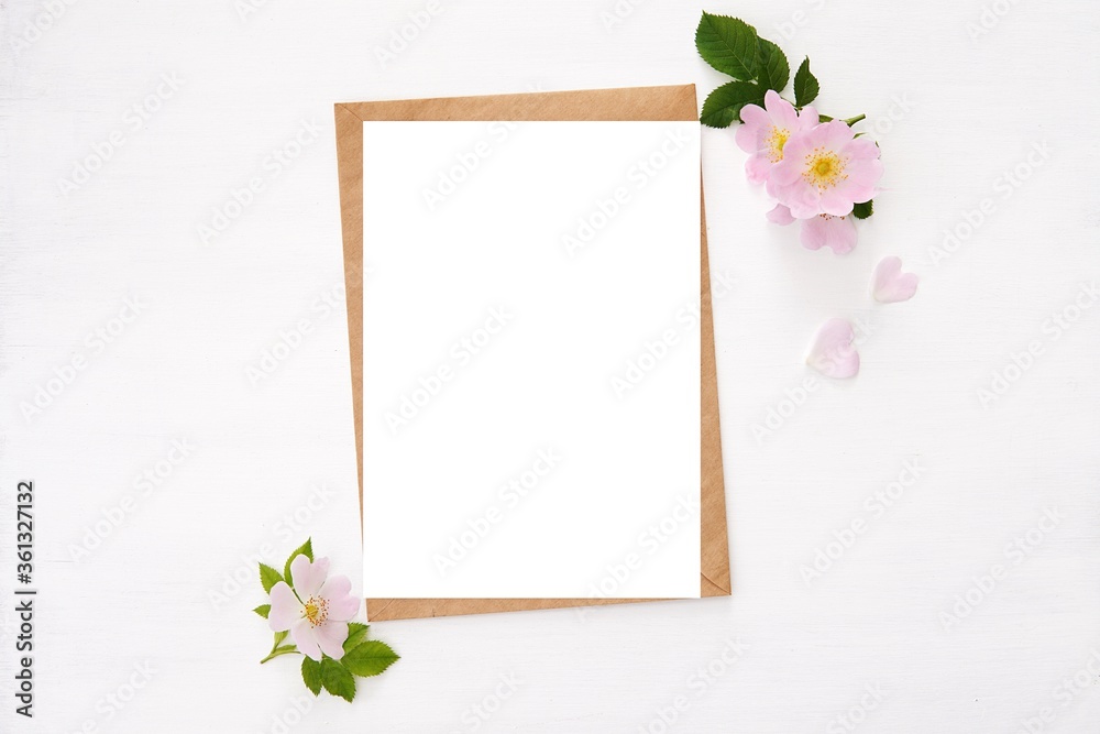 Fototapeta Greeting card, wedding invitation mockup, feminine stationery with pink flowers, vertical blank white paper card and envelope for design or text display.