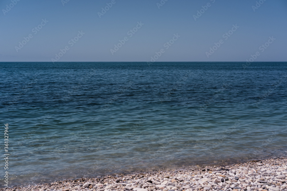Clear blue-blue sea with a rocky shore. Black sea coast.