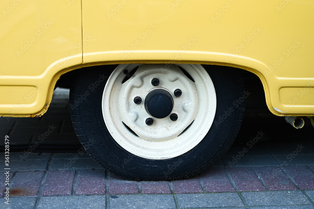 Wheel of a yellow van close-up