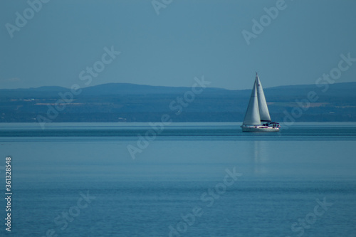 Sailboat On the Sea With Distant Mountains