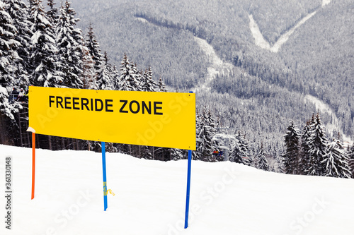 yellow symbol with warning about free ride zone on ski resort in winter on mountains 
