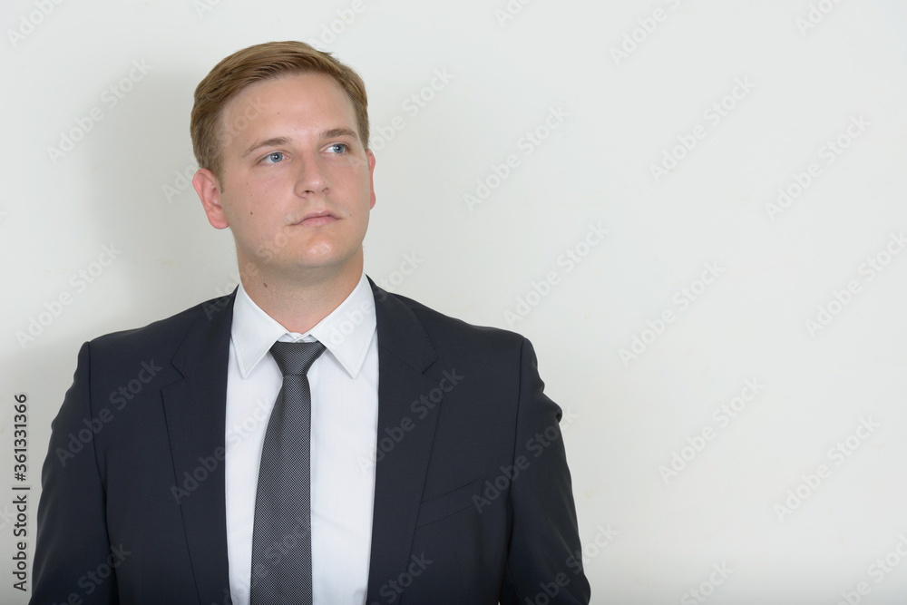 Portrait of businessman with blond hair thinking and looking up Portrait of businessman with blond hair thinking and looking up
